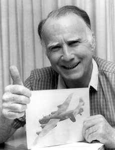 Tom Scotland DFC displays a photo of his aircraft